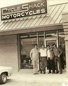 Richard Sanders, Don Schultz, Lyle Lovett, and Robert Tuggle at the Cycle Shack in Bellaire, Texas.